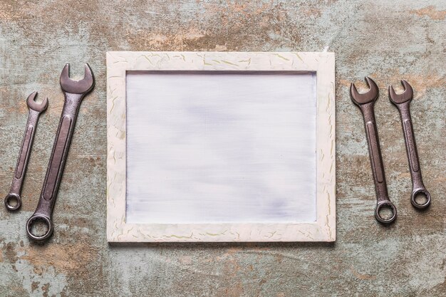 Photo elevated view of picture frame near combination wrench