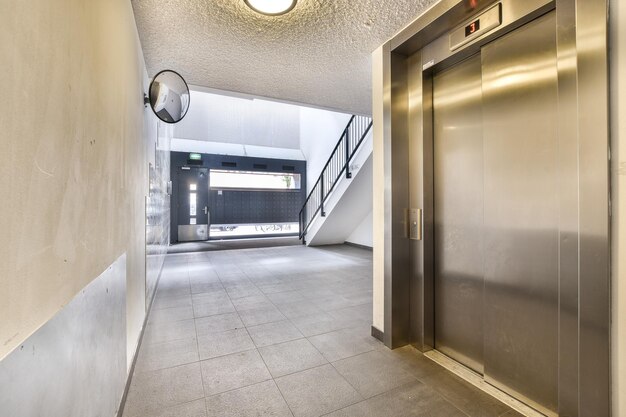 an elevator lobby in a building with an open door