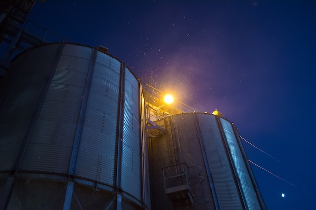 Elevator at night sometimes performs work on receiving, cleaning, drying and storing grain