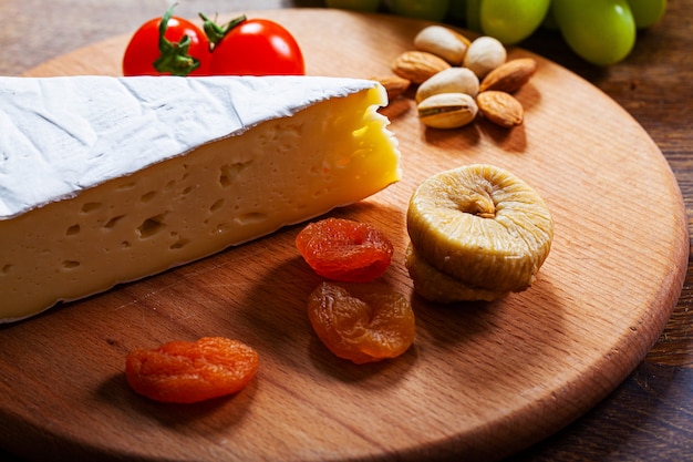 Elite variety of cheese on a wooden board