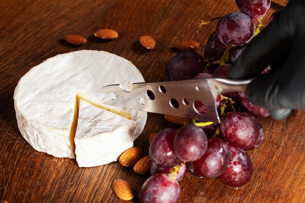 Elite variety of cheese on a wooden board.