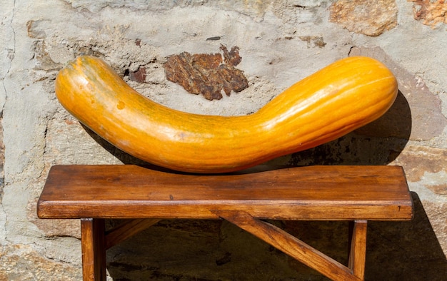 an elongated yellow pumpkin on a table