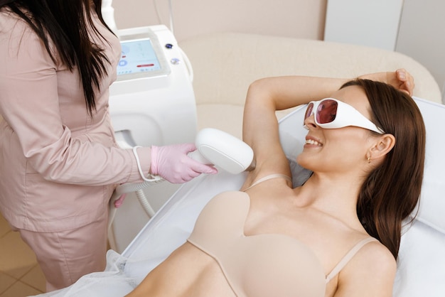 Elos epilation hair removal procedure on a womans body beautician doing laser rejuvenation