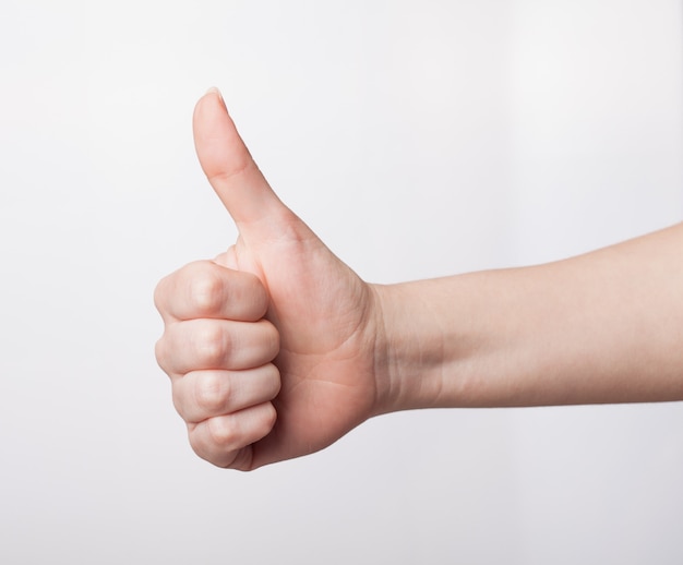 Emale hand showing thumbs up gesture