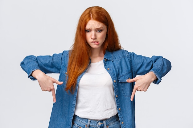 Embarrassed and worried, anxious cute redhead girl dropped something