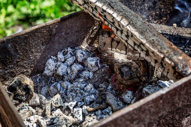 Embers burning in a brazier. Picnic in the nature. Close-up.