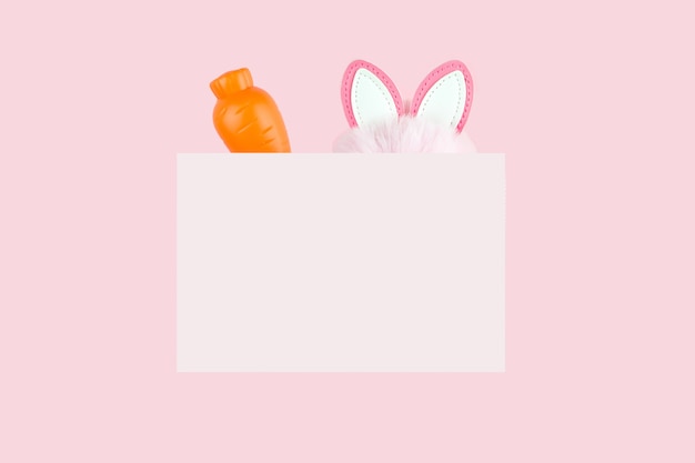 Emblem with carrot and hare ears on pink. Spring holiday design.