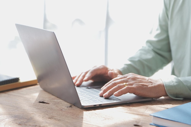 Embraced mature couple surfing the Internet on laptop at home