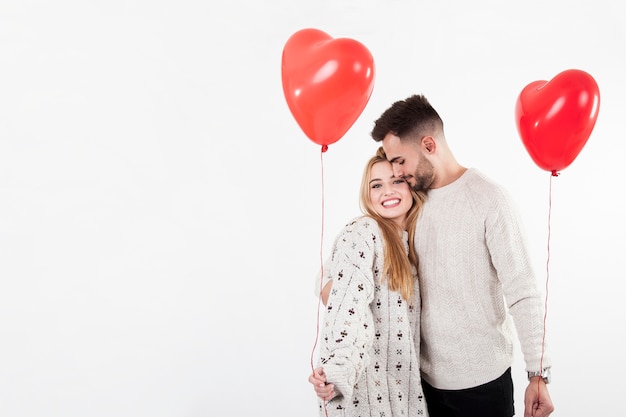 Embracing couple with balloons