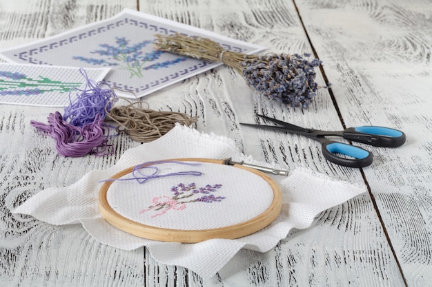 Embroidery bouquet of lavender and tools of needlework