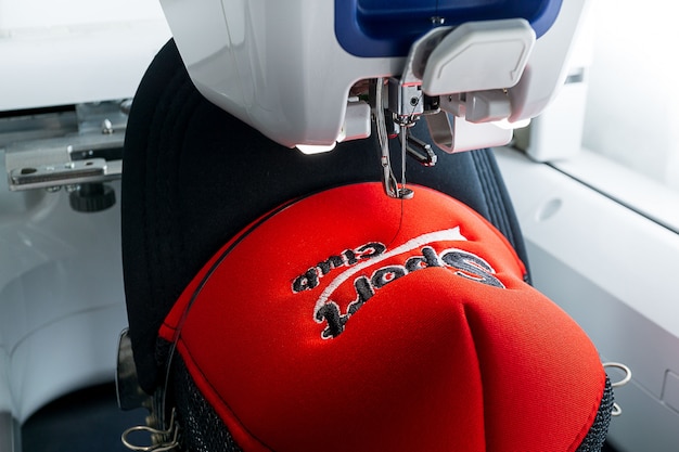 Embroidery machine and sport cap close up picture