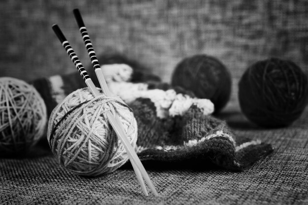 Embroidery wool balls and knitting needles