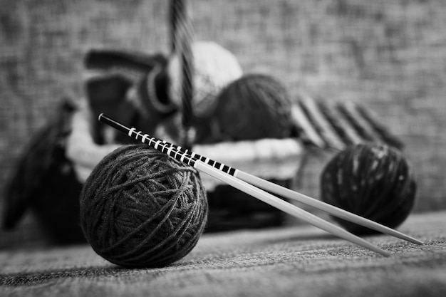 Embroidery wool balls and knitting needles