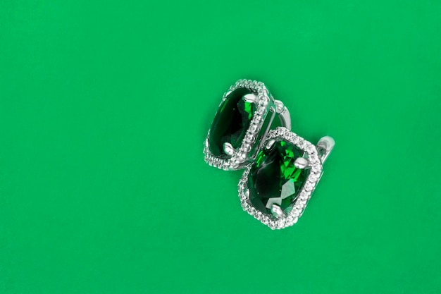 Emerald earrings on green