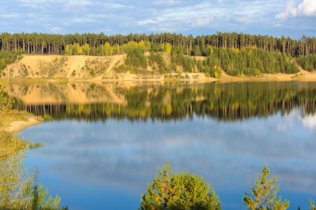 Emerald Lake with textural clouds, sandy mountains and forest. View from a high mountain. Kazan, Russia.