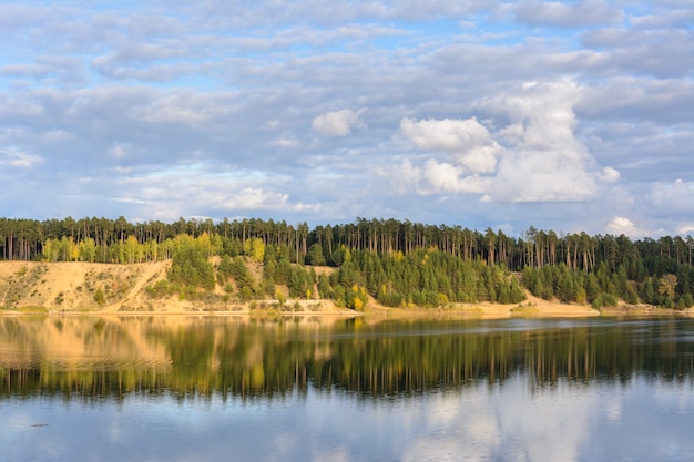 Emerald Lake with textural clouds, sandy mountains and forest. View from a high mountain. Kazan, Russia.