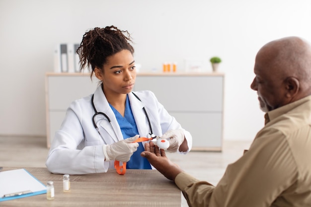 Emergency call system doctor giving alarm button to senior man