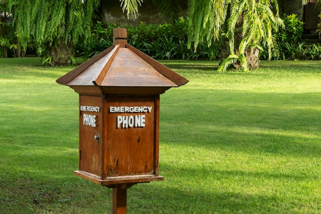 Emergency phone in a wooden booth on the outside