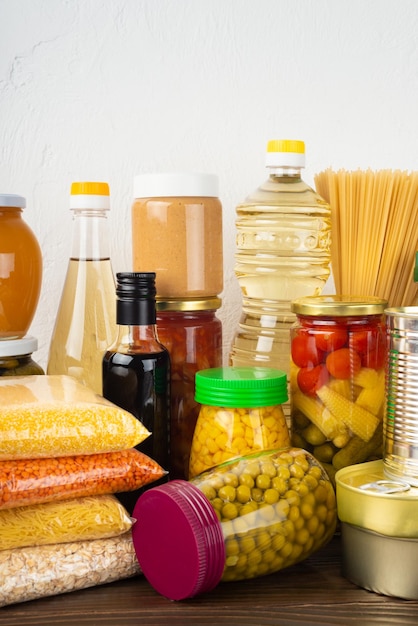 Emergency survival food set on dark wooden kitchen table