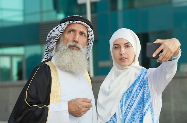 Emirati couple taking photos or selfie