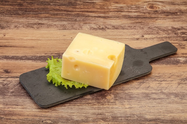 Emmental cheese over wooden board