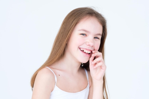 Emotion face happy child with playful and frolic smile little girl portrait on white background mood feelings personality and facial expression concept