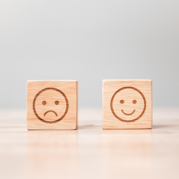 Emotion face symbol on wooden blocks Service rating ranking customer review satisfaction evaluation and feedback concept