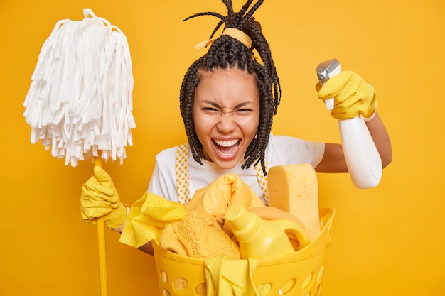 Emotional African American woman busy cleaning