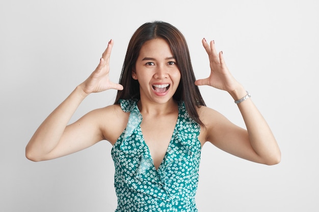 Photo emotional asian thai girl throws up hands, screams loudly, feels stress, irritation and anger isolated on white background