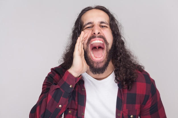 Emotional bearded man on gray background