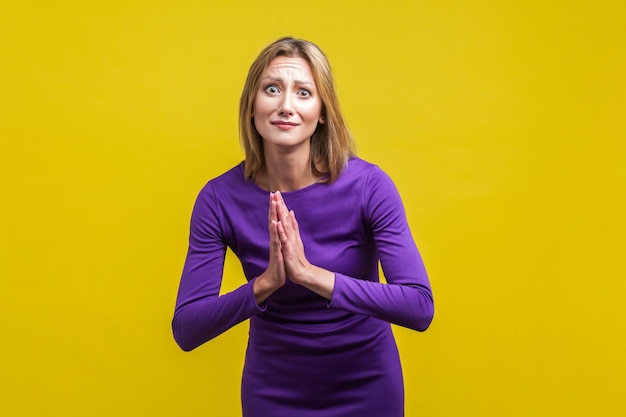 Emotional beautiful woman on yellow background