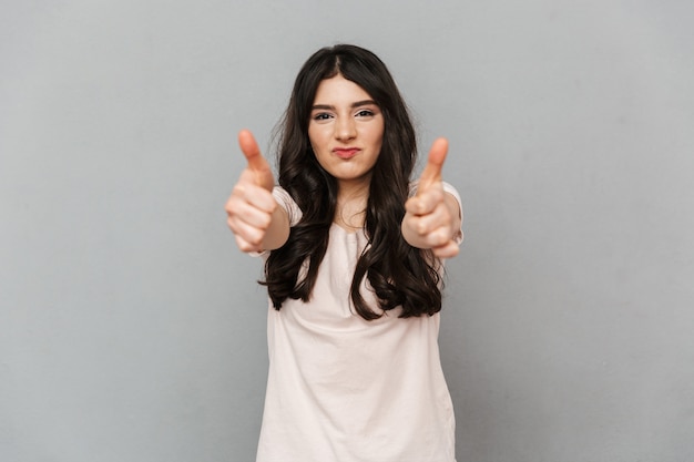 Emotional beautiful young lady make thumbs up gesture.