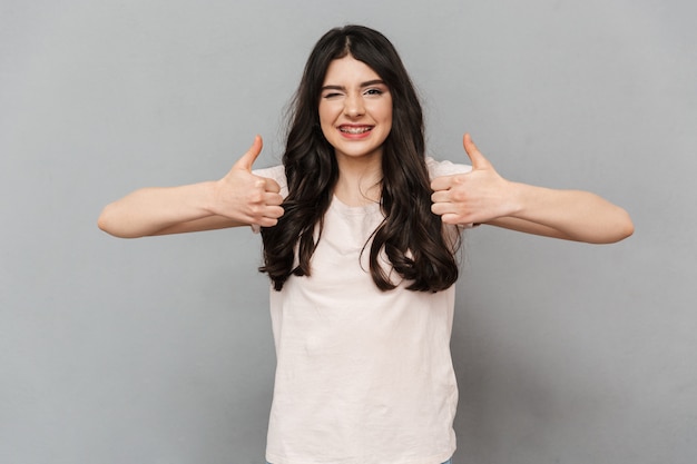 Emotional beautiful young lady make thumbs up gesture.