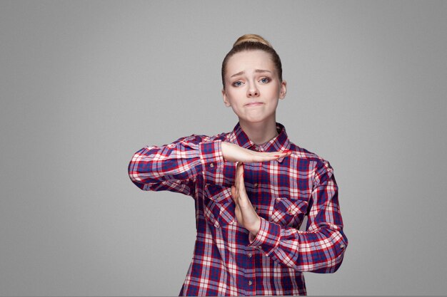 Emotional blonde girl on gray background