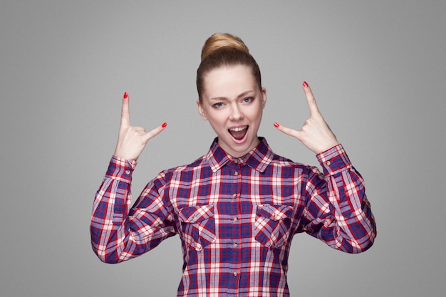 Emotional blonde girl on gray background