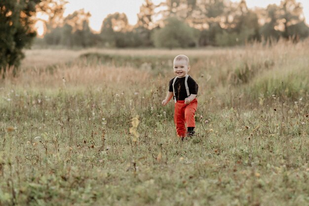 Emotional boy on the grass in the field