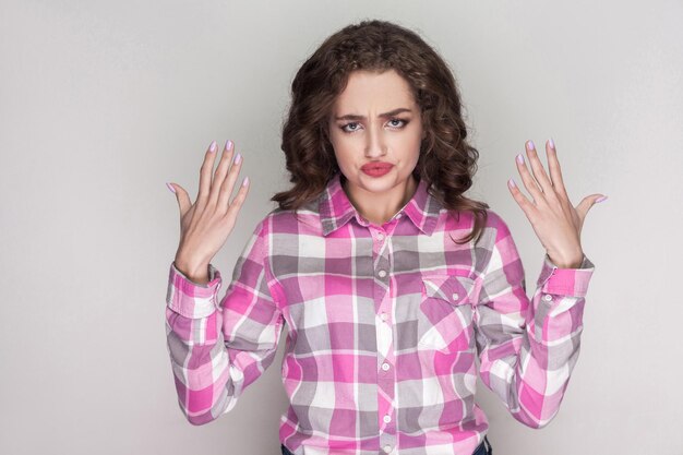 Emotional brunette girl on gray background