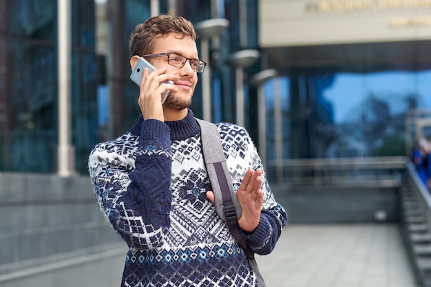 Emotional business man freelancer talking on the phone. Successful conversation with a partner or client