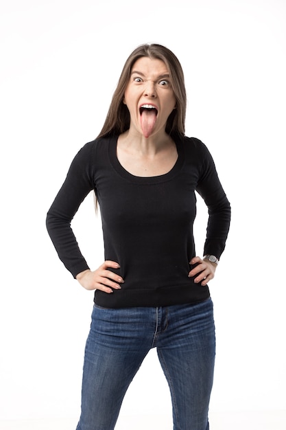 Emotional caucasian young woman showing her tongue. Isolated portrait