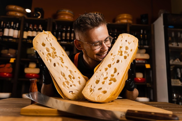 Emotional cheese sommelier having fun with pieces of limited maasdam natural aged Creative idea for cheese food photo for advertising