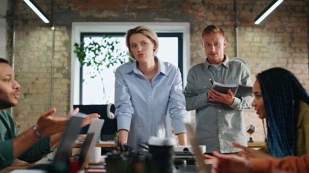 Emotional colleagues disputing office meeting multiracial coworkers discussing