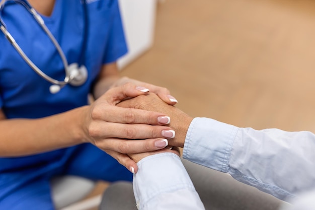 Photo emotional comfort stored in fingerprints shot of an unrecognizable doctor holding hands with her patient during a consultation