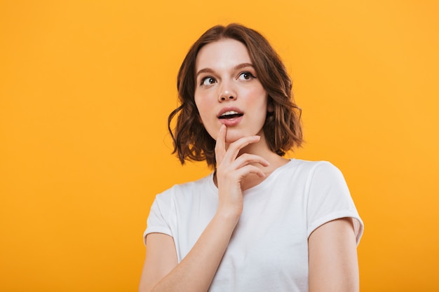 Emotional cute young woman standing isolated