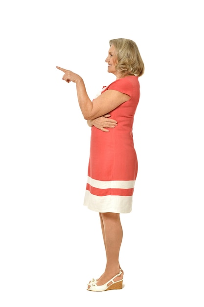 Emotional elderly woman showing something on a white background