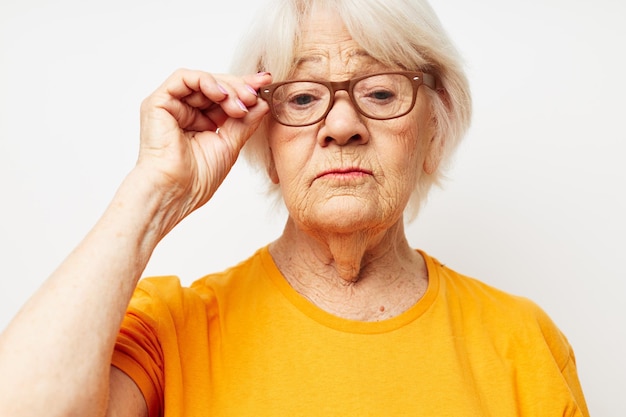 Emotional elderly woman vision problems with glasses isolated background