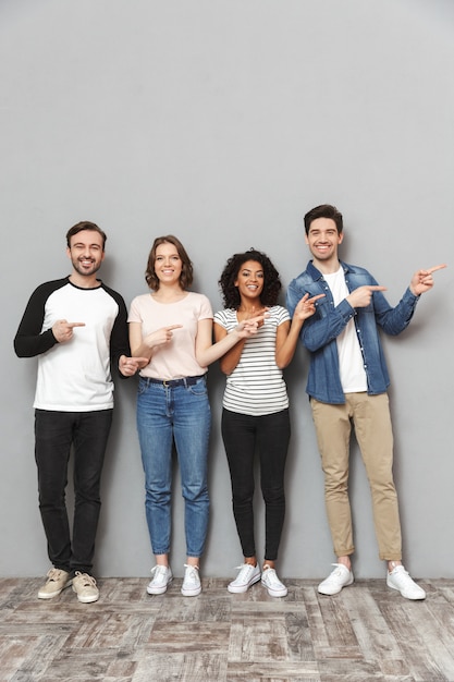 Emotional excited group of friends pointing.