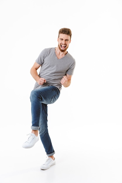 Emotional excited young man isolated