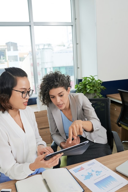 Emotional female entrepreneur asking assistant to correct mistakes in contacr document