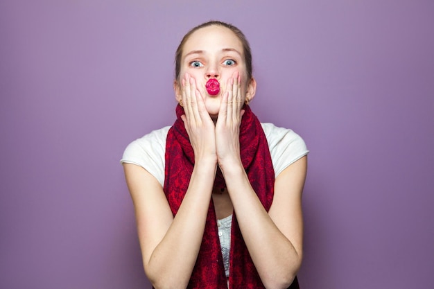 Emotional girl posing on purple background