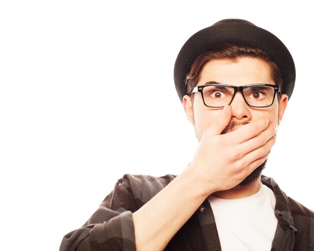 Emotional, happiness and people concept:. Young man  wearing black hat.Studio shot over white background.